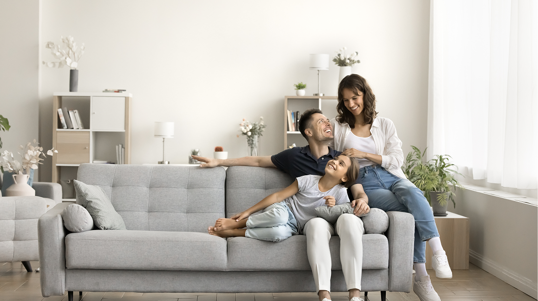 Family relaxing on gray sofa