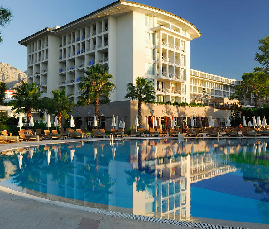 Resort building reflected in swimming pool